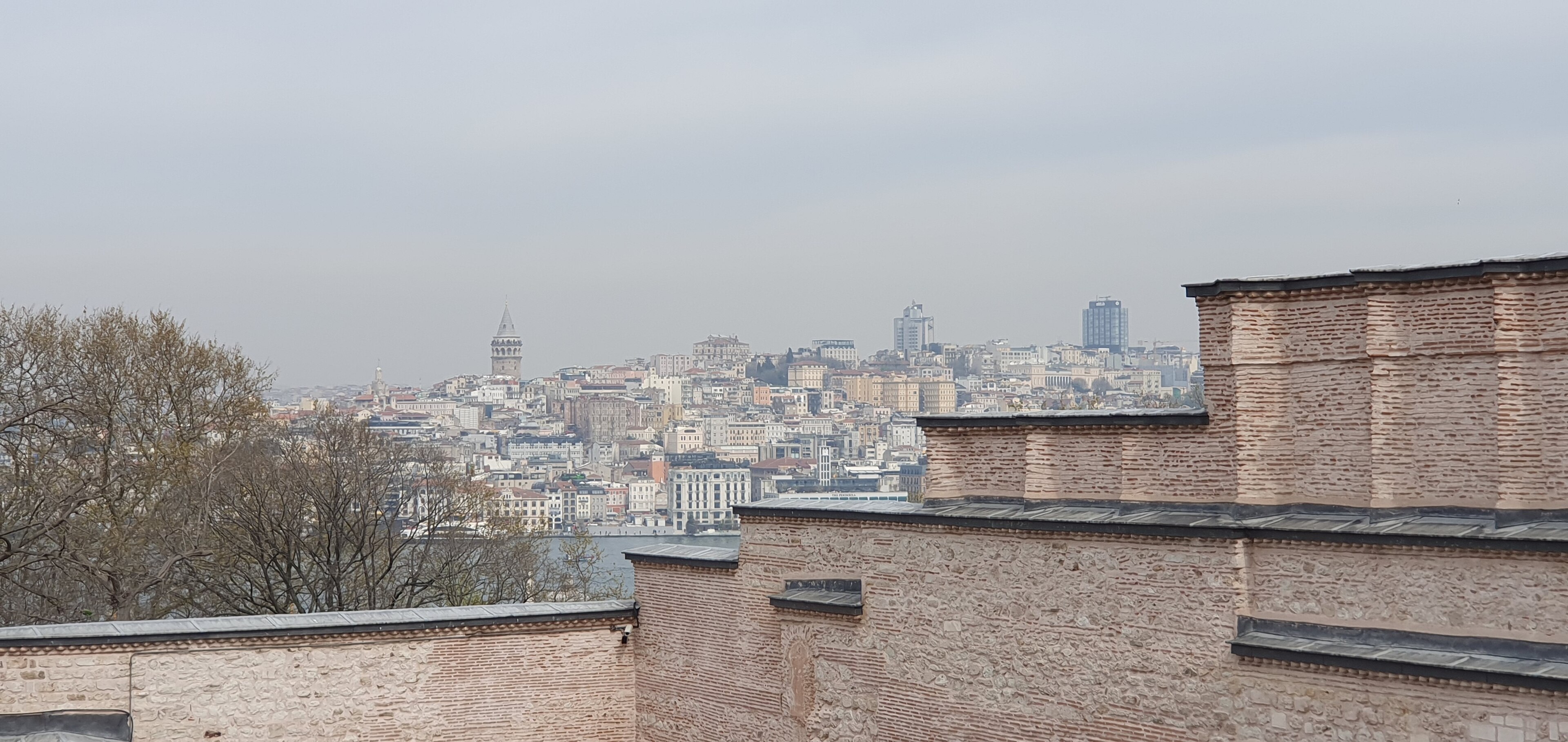 A panoramic view of the Beyoğlu district seen from Topkapı Palace, with the Galata Tower rising above the rooftops