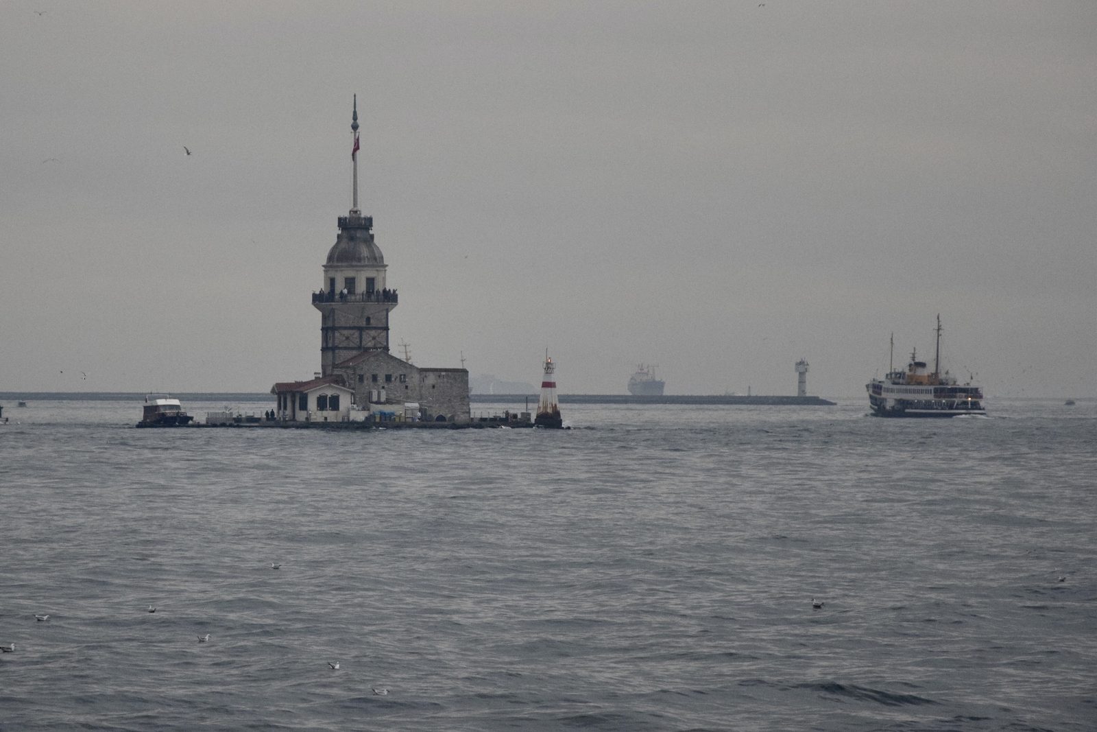 The Maiden's Tower (Kız Kulesi) sitting on its small islet at the southern entrance of the Bosphorus, with the Sea of Marmara around it and the Asian-side hills of Üsküdar in the background